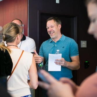 Professor Jeff Driskell speaking with audience members at the 2019 TEDxSalemStateUniversity event
