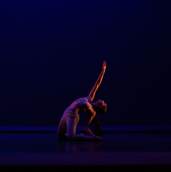 woman kneeling and bending back with arm extended