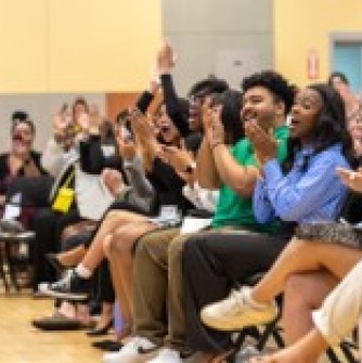 Photo from the CJL ALANA Graduation Ceremony 2024. Students seated, cheering and clapping.