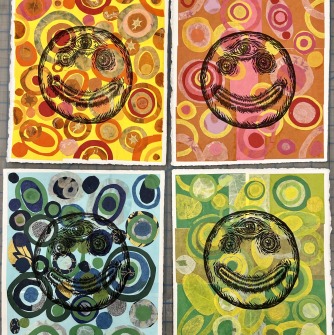 A multi-color square with a smiley face in each quadrant
