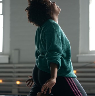 Person kneeling with arms extended