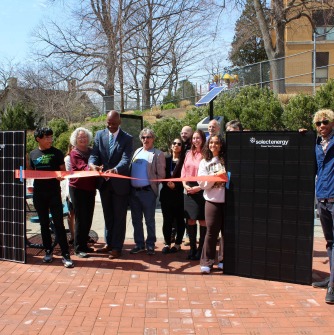 Salem State students, leaders, community members, and representatives from Solect Energy and PowerOptions cut the ribbon at a ceremony outside of the Ellison Campus Center for the university’s newest solar installations.