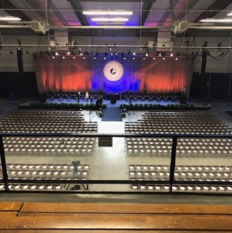 Empty stage and arena set up for Commencement in the O'Keefe Complex