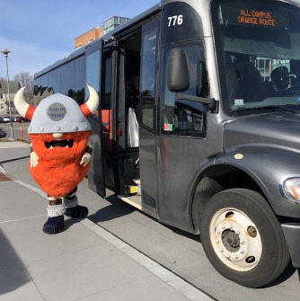 Superfan getting aboard a university shuttle bus
