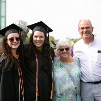 Graduate and family members pose together after ceremony