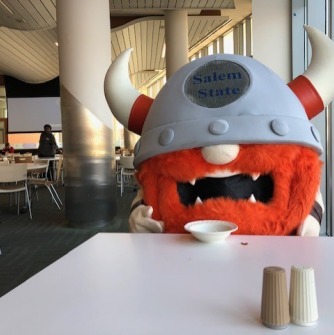 Superfan sitting at a lunch table in Marsh Dining Hall