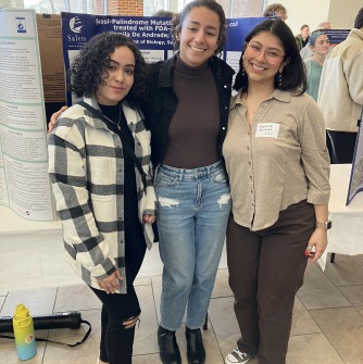 Salem State Biology presenters Kamila De Andrade (middle) and Pamela Rosales (right) with fellow biology major Serina Peña.