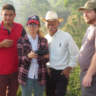 Danny overseeing trainees working with a coffee farmer on mapping a plantation