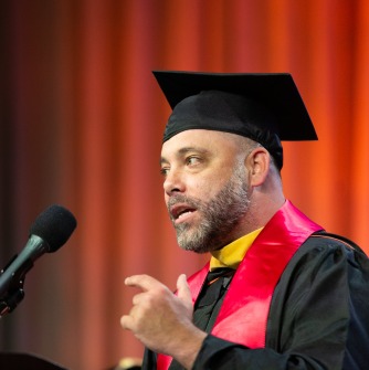 Joseph Tocci at the podium speaking during commencement