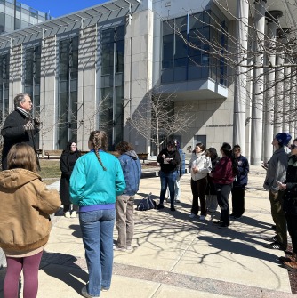 Salem City Planner Tom Daniels talks to geography and sustainability students outside Salem City Hall