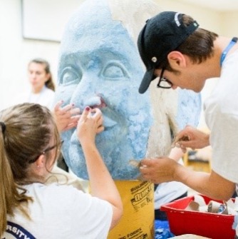 Students helping build a sculpture as part of day of service