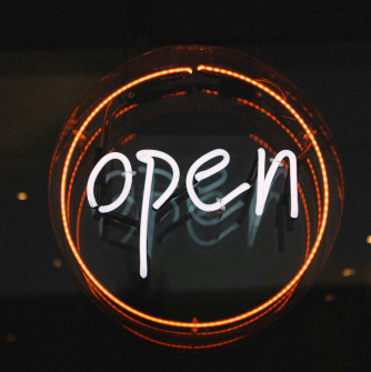 Neon Sign in Orange that says "OPEN"