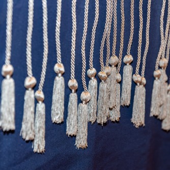 Image of silver cords hanging over a blue tablecloth