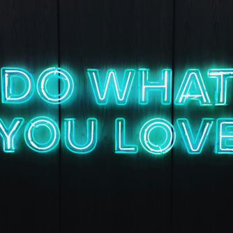 Words "Do what you love" in neon blue on black background