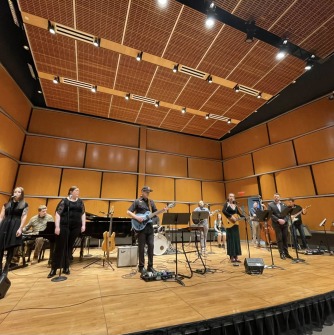 Musicians on a stage with many instruments