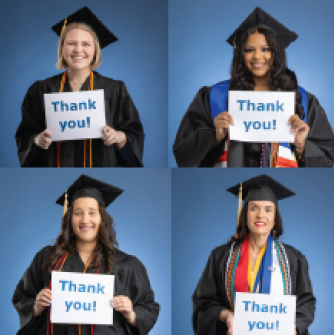 Graduates in regalia holding signs of gratefulness during commencement