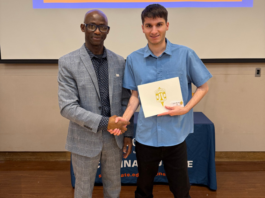 Prof. Minteh presents award to CJ student