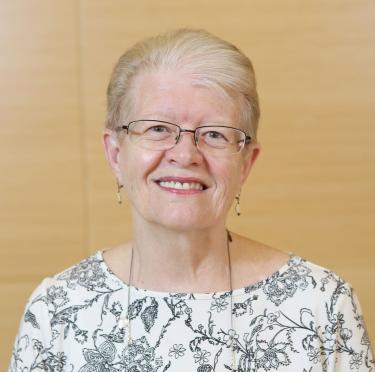 Kathy Skrabut wearing a light-colored patterned top