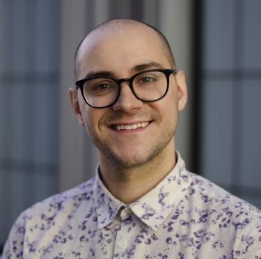 Ryan Goodwin wearing glasses and smiling at the camera