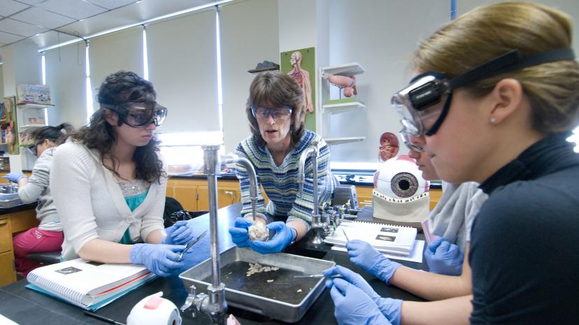 faculty with students in science lab