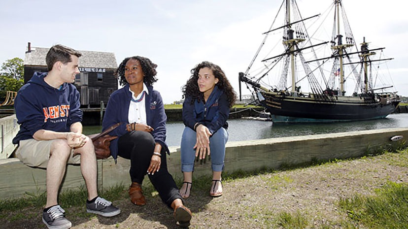 Salem State students in front of the FRIENDSHIP along the ocean in Salem