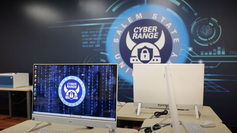 Cyber Range graphic wall with Mac computer