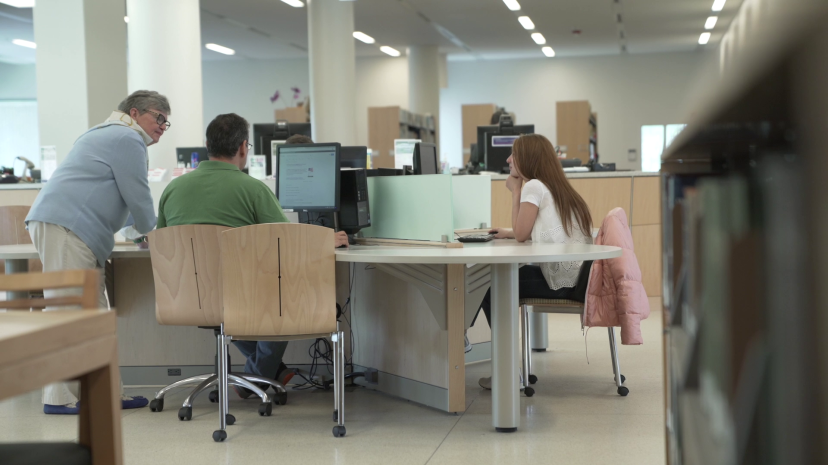 Students use computers in the library during a class.