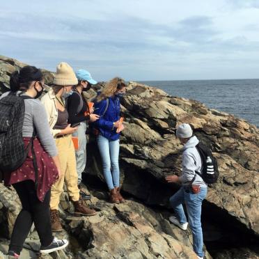 Geology students on a rocky coast 