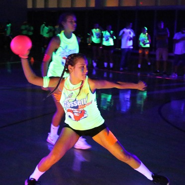 Woman playing blacklight dodgeball